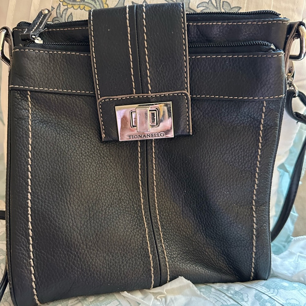 Tignanello black pebble woman’s crossbody bag.